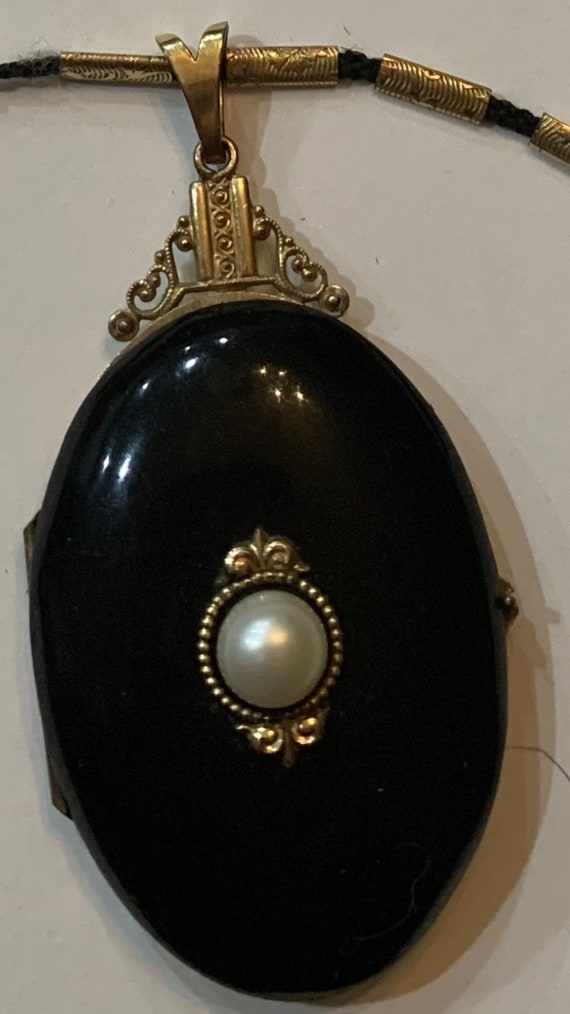 Enamel black oval locket Victorian with human hair