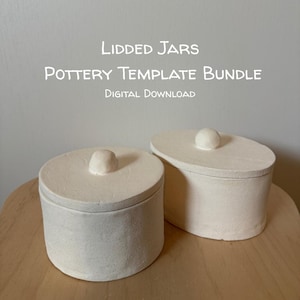 May include: Two off-white ceramic lidded jars with rounded knobs on top. The text Lidded Jars Pottery Template Bundle Digital Download is displayed above the jars. The jars have a matte, textured finish and simple cylindrical and oval shapes.