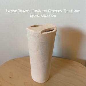 May include: A light beige ceramic travel tumbler with a distinctive angled top opening. The tumbler has a cylindrical shape with a gently widening base. The text "LARGE TRAVEL TUMBLER POTTERY TEMPLATE DIGITAL DOWNLOAD" is at the top.