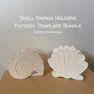 May include: Two off-white ceramic napkin holders featuring shell designs, one shaped like a spiral nautilus and the other like a fan-shaped scallop. The text reads: Shell Napkin Holders, Pottery Template Bundle, Digital Download.