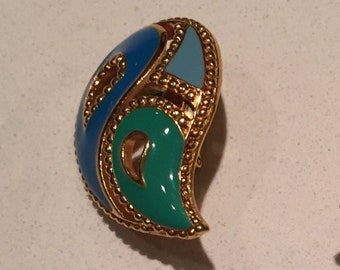May include: A pair of gold-tone earrings with blue, green, and light blue enamel. The earrings are shaped like a paisley design.