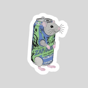 May include: A white ceramic mug with a black handle and the text "But First, Coffee" in a black, bold font. The mug is on a white surface.