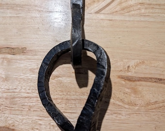 Hand forged door knocker made of railroad spikes