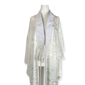 May include: A white sheer robe with a white satin collar and a tie belt. The robe has a subtle pattern throughout.