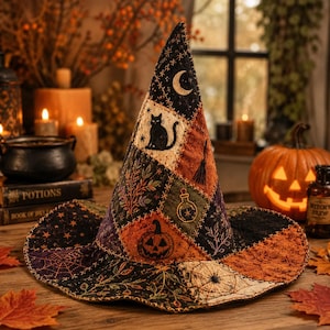 May include: A pointed witch hat featuring a patchwork design with embroidered motifs including a black cat, a crescent moon, a pumpkin, a broom, a potion bottle, spiderwebs, and botanical patterns in shades of black, orange, and green.