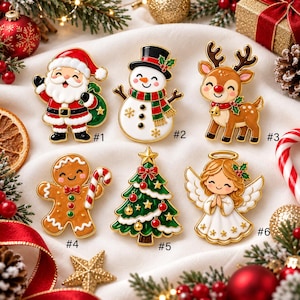 May include: Six Christmas-themed enamel pins labeled #1 through #6. The designs include a smiling Santa Claus, a snowman with a top hat, a reindeer with a red nose, a gingerbread man with a candy cane, a decorated Christmas tree, and an angel.