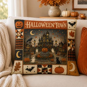 May include: A square throw pillow featuring a central illustration of a spooky town with a clock tower, pumpkins, ghosts, and a black cat. The text HALLOWEEN TOWN is printed at the top. The border consists of patchwork squares with pumpkins, leaves, bats, and moons.