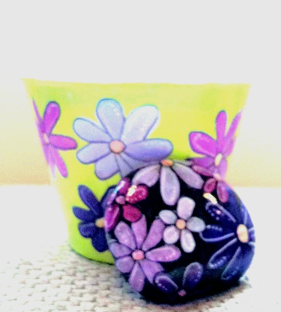 Terra cotta plant pot handpainted floral design with matching medium size rock.