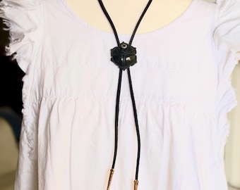 Black Flower Bolo Tie with Smoky quartz gemstone  on a black Leather suede strap.