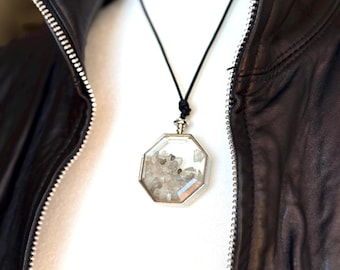 Flashy labradorite slices trapped in a beveled glass pendant.