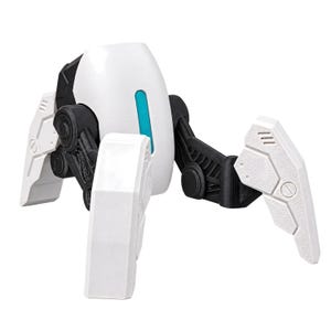 May include: A robotic figure with a smooth white rounded body, a vertical teal accent, and black mechanical joints connecting to four angular white legs. The legs feature textured surfaces with geometric paneling and circular recessed details.