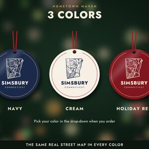 May include: Three circular ornaments in navy, cream, and holiday red, each featuring a white street map of Simsbury, Connecticut, and the text "SIMSBURY CONNECTICUT". Each ornament includes a red hanging string at the top.