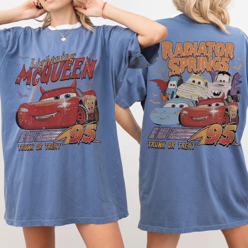 May include: Blue t-shirt with a Lightning McQueen graphic on the front and Radiator Springs on the back. The front design includes the text "Lightning McQueen" and "95", while the back design includes "Radiator Springs" and "Trunk or Treat".