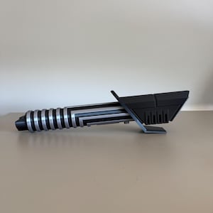 May include: A set of three ceramic mugs with a speckled, matte finish. The mugs are in shades of cream, light gray, and dark gray. Each mug has a simple, minimalist design, perfect for coffee or tea.