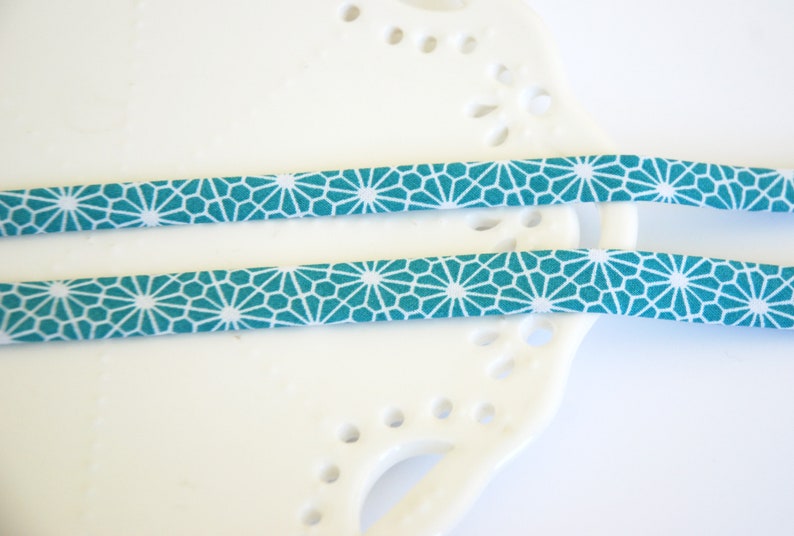 double fold geometric flower on turquoise CHOOSE 38 or 12 wide 3 yards bias tape