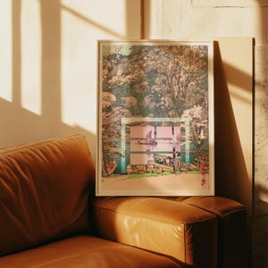 May include: A framed art print depicting a serene waterside scene with boats and figures. The artwork features a blend of pink, blue, and green hues, with a focus on the natural landscape and architectural elements. The print is displayed on a brown leather couch.