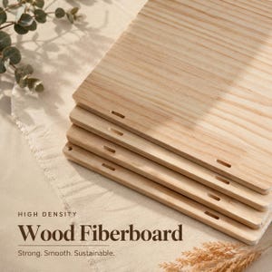 May include: A stack of four rectangular light-colored wood fiberboard panels with visible grain patterns. Each panel features a small, rectangular cutout near the edge. The text on the image reads: HIGH DENSITY Wood Fiberboard Strong. Smooth. Sustainable.
