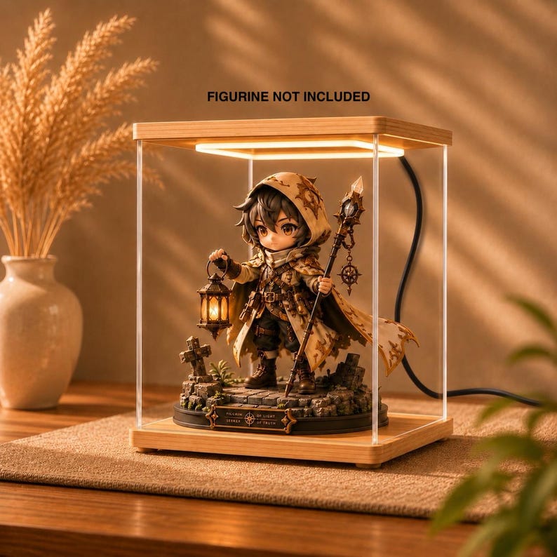 May include: A square wooden display case with a built-in LED light frame, housing a detailed fantasy character figurine holding a lantern and a staff. The text FIGURINE NOT INCLUDED is printed above the clear acrylic enclosure on the wooden top.
