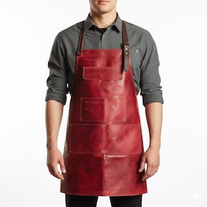 May include: A white ceramic mug with a black handle and the text "But First, Coffee" in a bold, black font. The mug is set against a blurred background, suggesting a cosy setting.