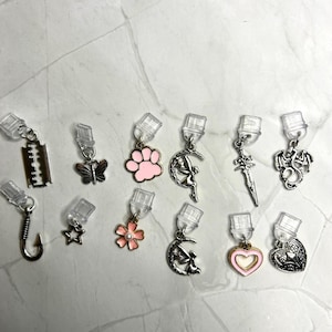 Charm-dammpluggar: Fjäril, Blomma, Fe, Drake, Hjärta, Rakblad, Krok, Stjärna, Tassavtryck