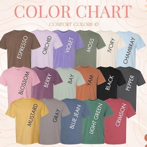 May include: A color chart featuring a variety of Comfort Colors t-shirts. The shirts are displayed in a range of colors, including Espresso, Orchid, Violet, Moss, Ivory, Chambray, Blossom, Berry, Bay, Yam, Black, Pepper, Mustard, Gray, Blue Jean, Light Green, and Crimson.