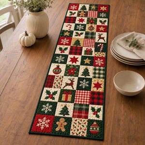 May include: A rectangular quilted table runner featuring a patchwork design of alternating squares. The fabric squares display various Christmas motifs including gingerbread men, reindeer, snowflakes, pine trees, holly, gifts, and ornaments in red, green, and cream colours.