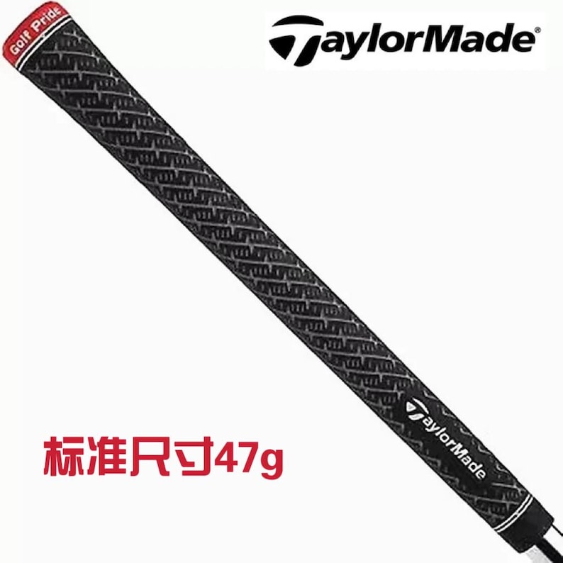 May include: A black and gray golf club grip with a textured pattern. The grip has a red and white band that says "Golf Pride". The TaylorMade logo is visible. The text "Standard Size 47g" is also visible.