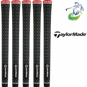 May include: Five black golf club grips with a textured pattern and the "TaylorMade" logo. Each grip has a red and white band at the top with "Golf Pride" printed on it. A logo with a golfer and the "TaylorMade" logo are also visible.