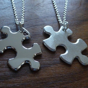 Two Matching Silver Puzzle Piece Pendant Necklace, one satin one polished