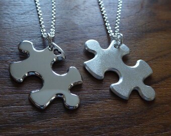 Two Matching Silver Puzzle Piece Pendant Necklace, one satin one polished