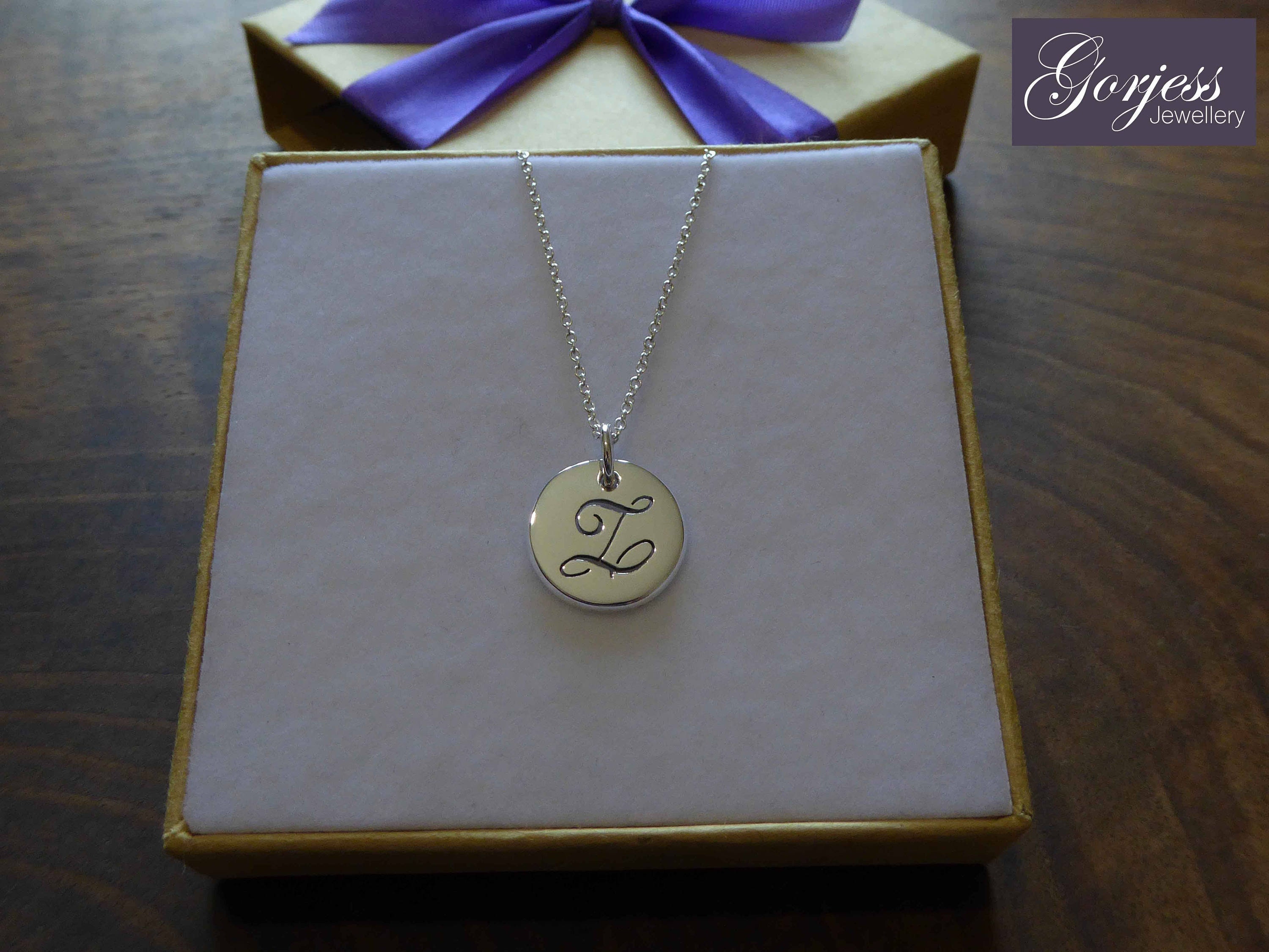 Tiffany Notes alphabet disc charm in silver on a chain. Letters A-Z  available.