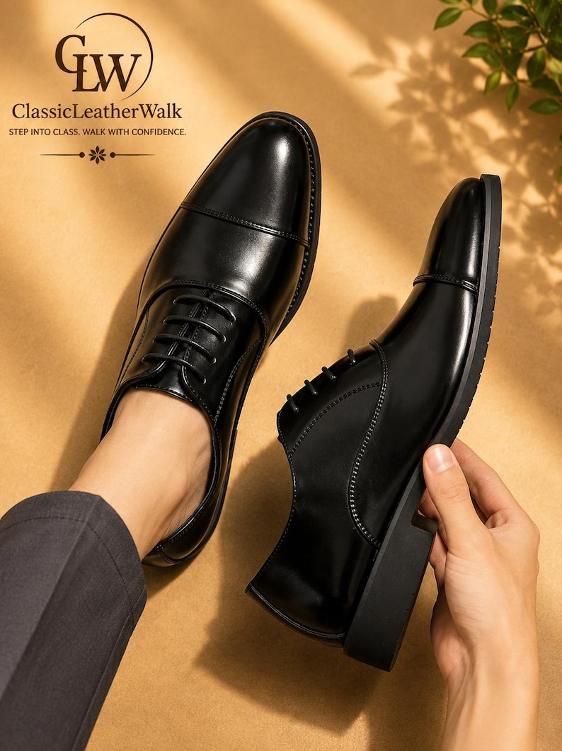May include: A pair of black leather oxford shoes with a cap toe design and black laces. The shoes feature a smooth finish and a low heel. The text GW ClassicLeatherWalk STEP INTO CLASS. WALK WITH CONFIDENCE. is visible in the upper left corner.