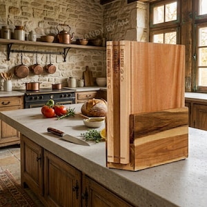 May include: Wooden cutting board set with a holder, displayed on a kitchen countertop. The set includes three boards with titles: Fruits & Vegetables, Cheese & Bread, and Meat & Fish. The kitchen features a stone wall and wooden cabinets.