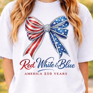 May include: White t-shirt with a patriotic bow design in red, white, and blue, with a sparkling centre. The text "Red White & Blue" and "AMERICA 250 YEARS" are printed below the bow.