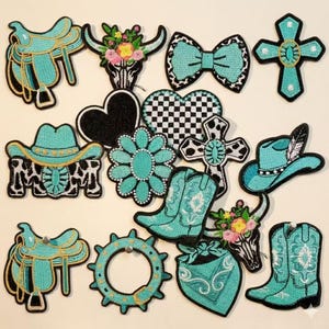 May include: A collection of embroidered patches in a Western theme. Designs include cowboy hats, boots, saddles, crosses, and a bow tie, all in shades of turquoise, black, and white. Some patches feature floral accents and cowhide patterns.