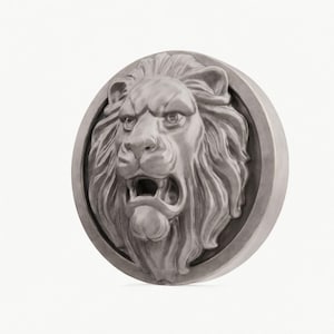 May include: A detailed, gray-toned relief sculpture of a roaring lion's head, set within a circular frame. The lion's mane is textured, and its mouth is open, revealing teeth. The artwork is likely made of a durable material.