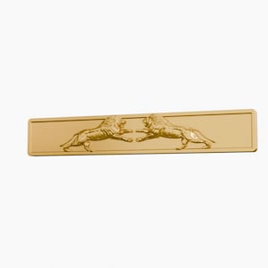 May include: A rectangular gold-toned metal cabinet pull featuring a raised relief design of two lions facing each other in the center. The hardware has a smooth, polished finish with a thin border frame surrounding the central lion motif.