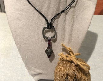 SPIRALING MOON: Doubled Black Leather Cord w Can Tab Pendant Accented w Garnet Crystal & Stripe Metal Beads. Matching Earrings. 2pc Set.