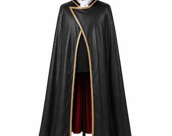 May include: A black floor-length cape featuring a high standing collar with a deep red interior lining and gold trim along the edges. The garment is worn over a black top with a white cravat or neck accessory, displayed on a mannequin form.