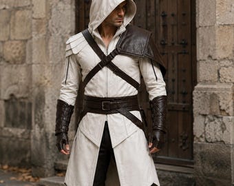 May include: A white hooded jacket featuring a structured collar, a front zipper, and layered shoulder detailing. It is accented with dark brown leather-like straps, a wide buckled belt, and matching fingerless gauntlets over dark trousers.