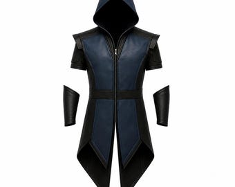 May include: A sleeveless hooded vest in black and dark blue with a front zipper closure, featuring a long pointed hemline and matching black forearm guards. The garment has structured shoulders and a central blue panel on the front and hood.