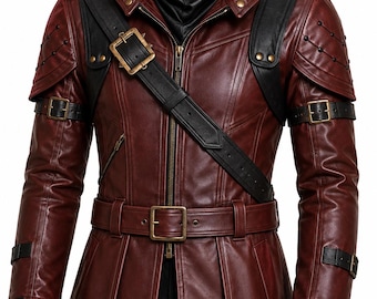 May include: A dark red leather jacket featuring black leather accents, a front zipper closure, and a high collar. The garment includes a diagonal chest strap with a brass buckle, shoulder epaulets, and adjustable buckled straps on the sleeves.