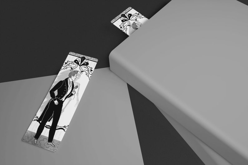 May include: Two black and white bookmarks with a decorative design featuring a couple in formal attire. The bookmark on the left is lying flat on a light grey surface. The bookmark on the right is partially sticking out of a closed book.