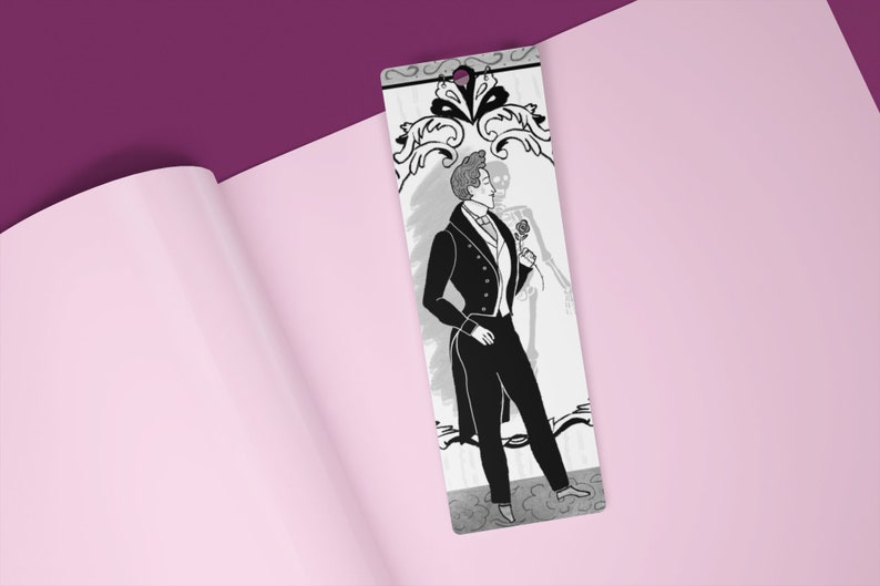 May include: Black and white bookmark featuring a man in a tuxedo holding a rose, with a skeleton behind him. The bookmark has a decorative floral design at the top.