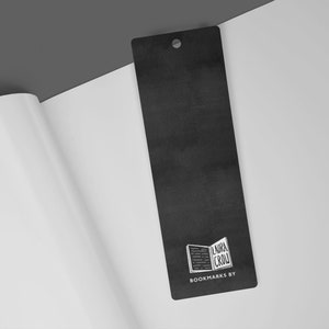 May include: A black bookmark with a white logo of an open book with the text "Laura Crow" and the words "Bookmarks By" below the logo.