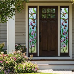 May include: A wooden front door with stained glass sidelights. The glass panels show hummingbirds and flowers in red, green, and purple against a light blue backdrop. The door is set in a beige exterior.