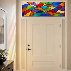 May include: A rectangular stained glass transom window featuring a vibrant, abstract wave pattern. The design consists of interlocking curved segments in shades of blue, red, green, orange, purple, and yellow, held together by dark metal lead lines.
