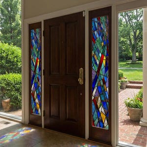 May include: A dark brown wooden front door with stained glass sidelights. The glass panels display a colourful design of geometric shapes in blue, red, yellow, and green, creating a vibrant and artistic entrance.
