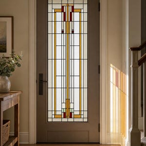 May include: A tall, rectangular door with a matte taupe finish and a central vertical stained glass panel. The glass features a geometric grid pattern in white, accented by vertical lines of amber yellow and deep red, with a black metal handle.