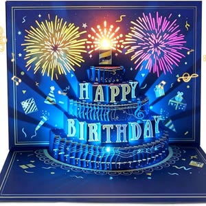 May include: A three-dimensional pop-up greeting card featuring a multi-tiered cake with the text HAPPY BIRTHDAY in gold lettering. The background is dark blue with yellow and pink fireworks, musical notes, and gift box illustrations.